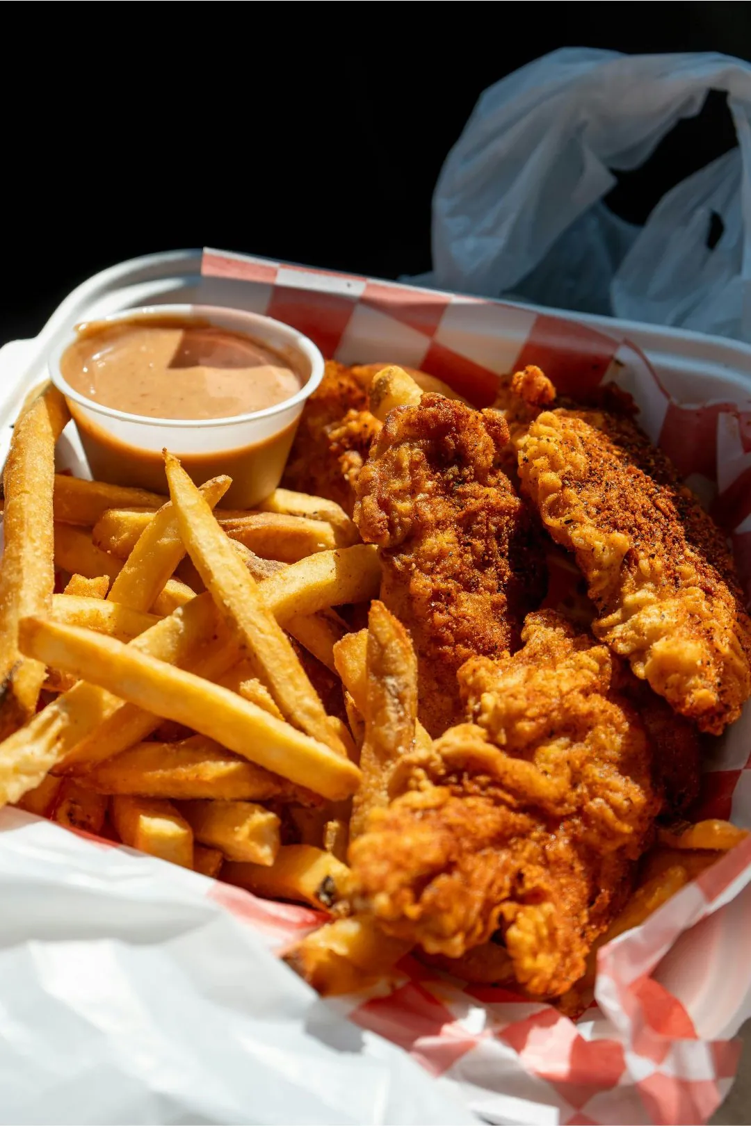 SuperFoody-Asian-Market-Fast-Food-Spot-Spicy-Chicken-Tenders-and-Fries-Arlington Spicy crispy chicken tenders with golden fries and dipping sauce at SuperFoody Asian Market, a Fast-Food Spot in Arlington